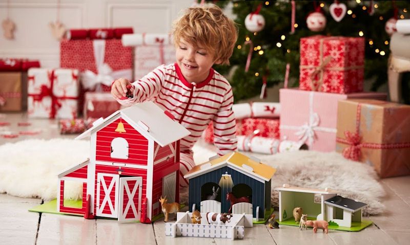 Child playing with ELC wooden farm set