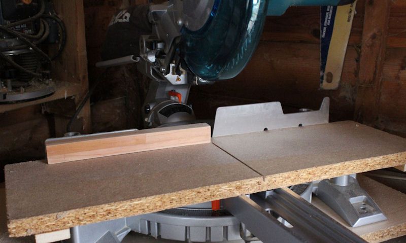 Template fixed to Makita mitre saw in workshop