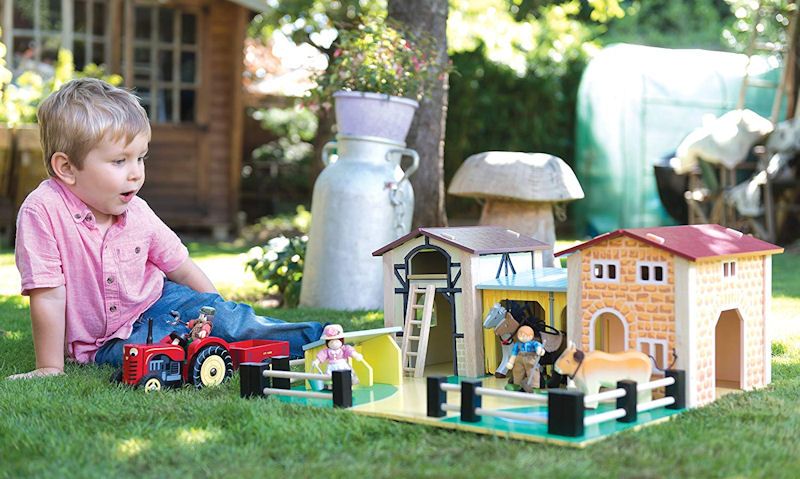 Child playing with farm set on floor